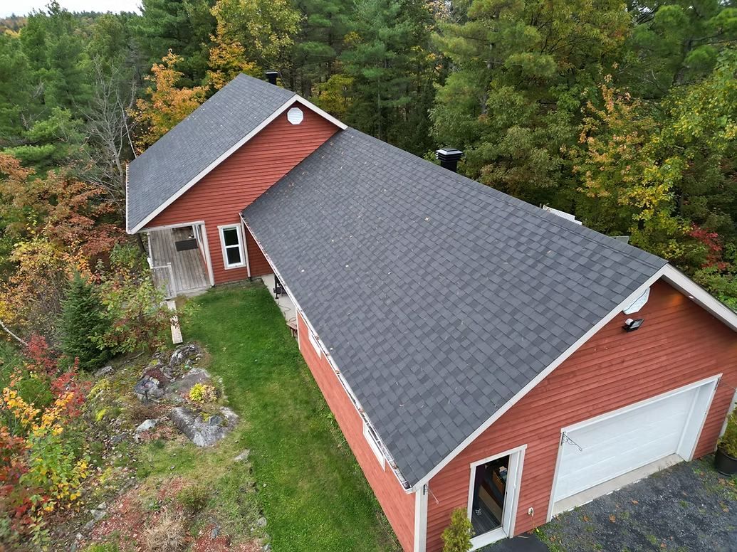 Toiture refaite sur une maison rouge en forêt